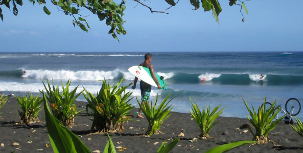 surfers at Taharuu beach in Papara